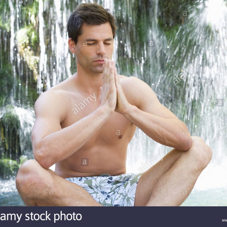 a-man-meditating-by-a-waterfall-B07M6C